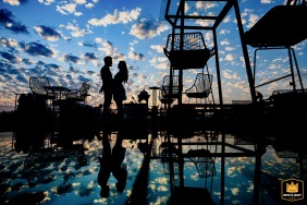 A romantic shot at a picture-perfect outdoor wedding in Udaipur, Rajasthan, capturing the love and joy between two people against a gorgeous sunset backdrop.